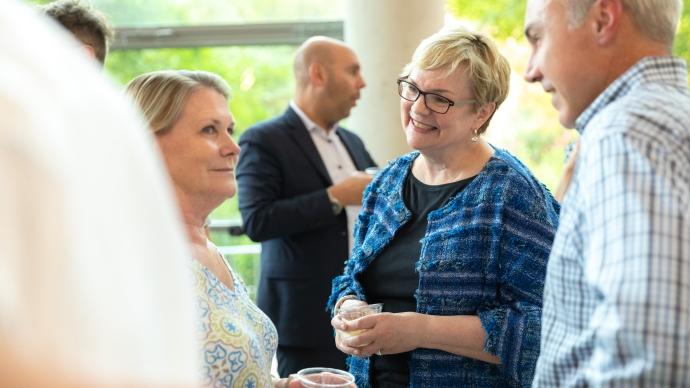 President Beasley talking to faculty and staff at a reception