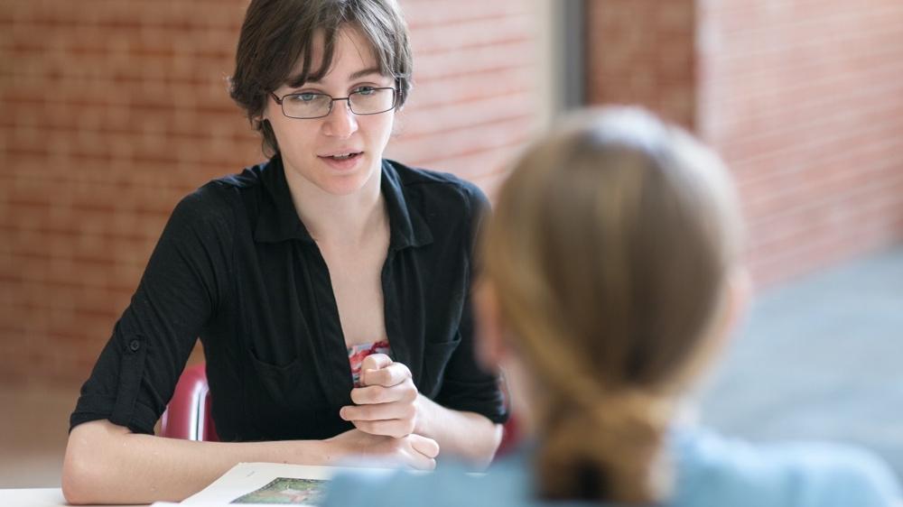 two people talking across a desk